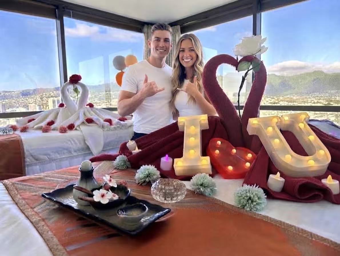 A couples spa room with red heart-shaped towels and a view of Honolulu